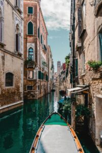 Scenic canal view with traditional boat between historic buildings in Europe